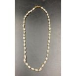 A pearl necklace set on 18ct gold with a clasp marked 750.
