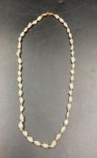 A pearl necklace set on 18ct gold with a clasp marked 750.