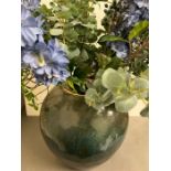 A large glazed terracotta style vase (45cm H) with faux flowers