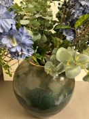 A large glazed terracotta style vase (45cm H) with faux flowers