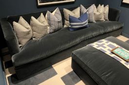A large deep blue velvet sofa with ottoman (Please be aware soft furnishings in photo being sold