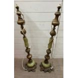 A pair of faux marble and metal tall lamps