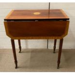 A Drop leaf side table on castors with reeded tapering legs and decorative inlay and a drawer to end