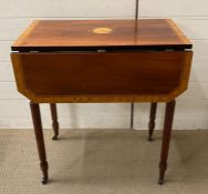 A Drop leaf side table on castors with reeded tapering legs and decorative inlay and a drawer to end