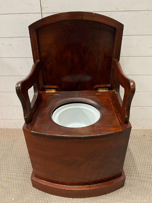 A mahogany commode with original pot