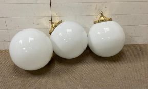 Three large spherical brass and white china ceiling lights