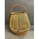 A natural rattan lantern with glass candle holder