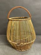 A natural rattan lantern with glass candle holder