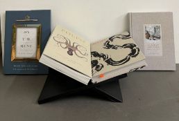 Four hard back cook books with contemporary stand