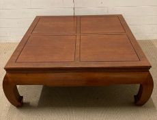 A hardwood Thai style table 42cm x 107cm sq.