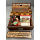 A checker games board box with various games inside including a crib board and cards.