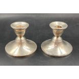 A pair of weighted sterling silver squat candlesticks 8cm H
