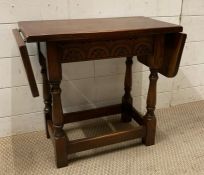 An oak drop sided side table (H49cm W87cm D29cm)