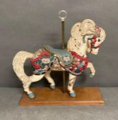 A Decorative carousel style horse mounted on a plinth