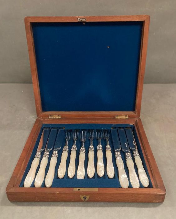 A boxed set, six place setting, mother of pearl and silver fruit knives and forks, hallmarked for