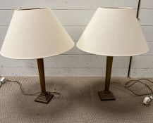 A pair of brass table lamps with square bases