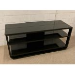 A glass topped black media unit (H49cm W110cm D42cm)