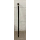 A walking stick with embossed metal top
