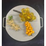 Decorative mix of glass grapes on a two handled chopping board