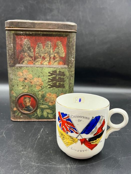 A vintage commemorative military biscuit tin possibly Boer War and a Champions of Liberty Cup
