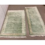 Two wool rugs with green grounds 185cm x 64cm and 162cm x 87cm