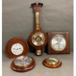 A selection of four contemporary barometers and a clock