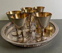 Six silverplate goblets on a tray with six napkin rings