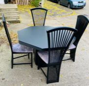 A black dining table with four chairs (H74cm Dia120cm)