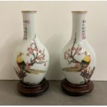 Two Chinese porcelain vases on plinths