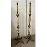 A pair of faux marble and metal floor standing lamps