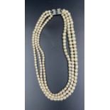 A Three strand pearl necklace with silver clasp.