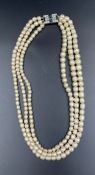 A Three strand pearl necklace with silver clasp.