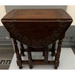 An oak drop side table with carved detail (H73cm W52cm D35cm)