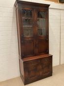 An oak glazed bookcase with carved doors to base by Bevan Funell (H222cm W96cm D51cm)