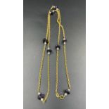 A gold necklace marked 583 with pearls and purple stones (Approximate Total weight is 28g)