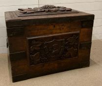 An English oak metal bound chest, shielded knight carving to side