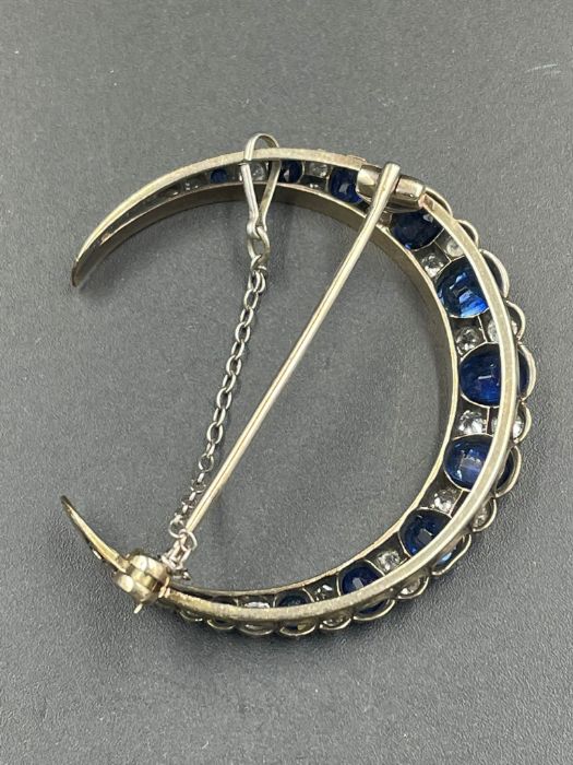 A Sapphire and diamond brooch with eleven graduated sapphires, each stone separated by diamonds. - Image 3 of 3