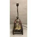 An Oriental style cast iron table lamp of a seated figure