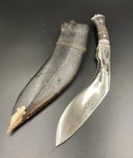 A Kukri style knife in leather sheath.