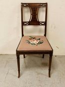 A hall chair with embroidered seat