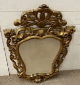 A gilt scrolling mirror, Italian style