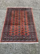 A red medallion wool rug/carpet (230cm x 140cm)