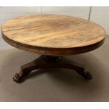 A pedestal centre table on tri form base and lion paw feet (H72cm Dia135cm)