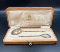 A Boxed pair of silver gilt engraved spoons in original oak box. Early 20th Century Russian.