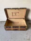 A antique brass banded travelling trunk