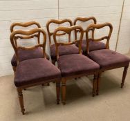 A set of six mahogany dining chairs upholstered in purple on turned front legs