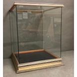 A wooden framed display case with a blue velvet lining to base