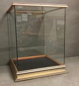 A wooden framed display case with a blue velvet lining to base
