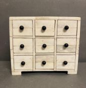 A nine drawer white jewelry or sewing box