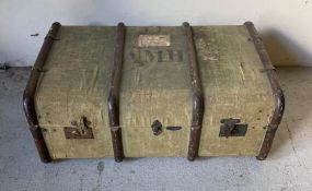 A antique canvas covered wooden banded travel trunk